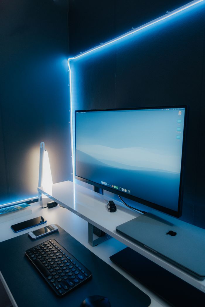 Mastering the First Impression: Your intriguing post title goes here A sleek and modern workspace setup featuring a desktop monitor, keyboard, and LED lighting.
